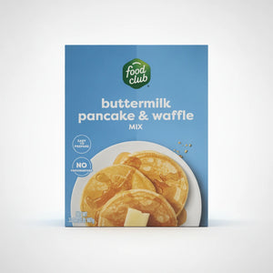 A high-resolution product photo of Food Club Buttermilk Pancake & Waffle Mix in a blue box with a green logo, featuring an image of pancakes with syrup and butter on a clean white background.