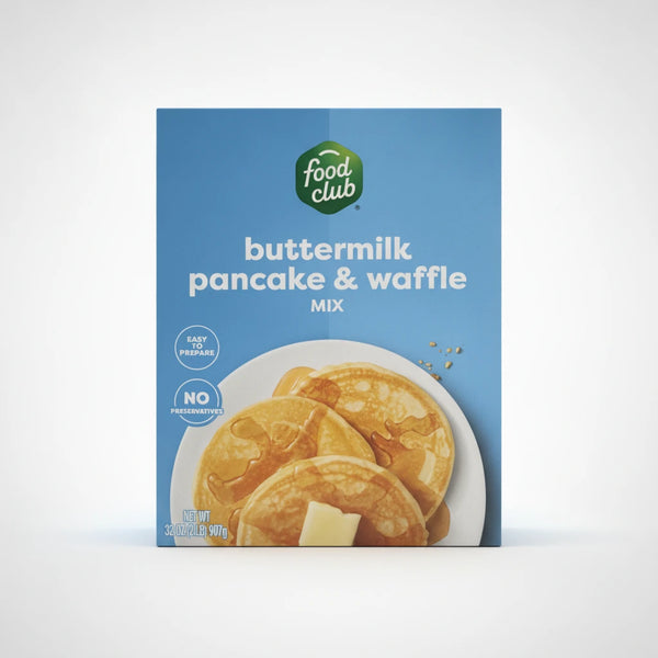 A high-resolution product photo of Food Club Buttermilk Pancake & Waffle Mix in a blue box with a green logo, featuring an image of pancakes with syrup and butter on a clean white background.