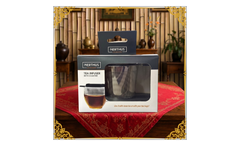 Front of Nerthus Tea Infuser with Coaster packaging on a decorated table