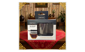 Front of Nerthus Tea Infuser with Coaster packaging on a decorated table